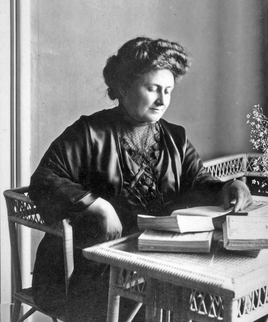 Maria Montessori reading a book, black and white photo