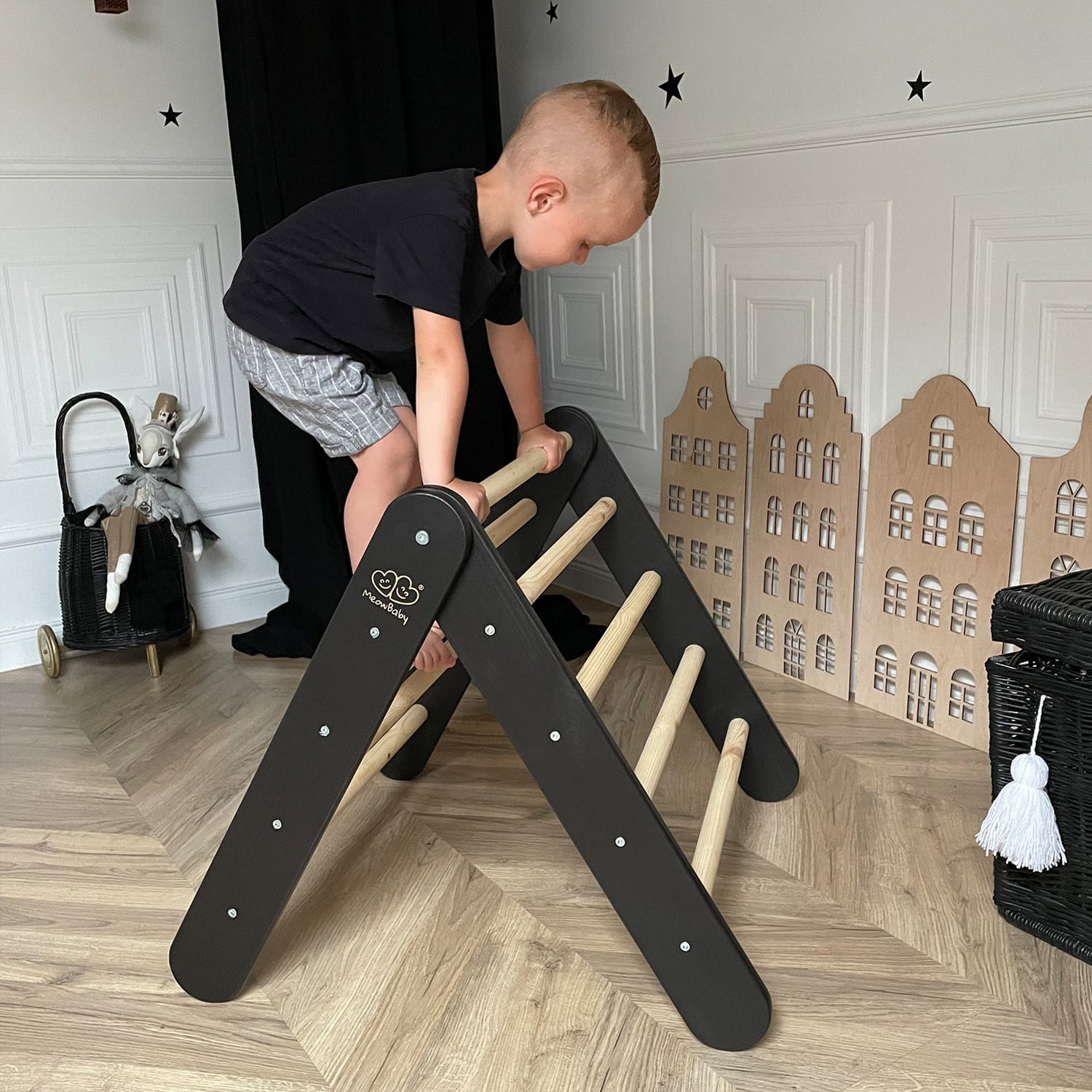 boy climbing on black pickler Mowbaby triangle