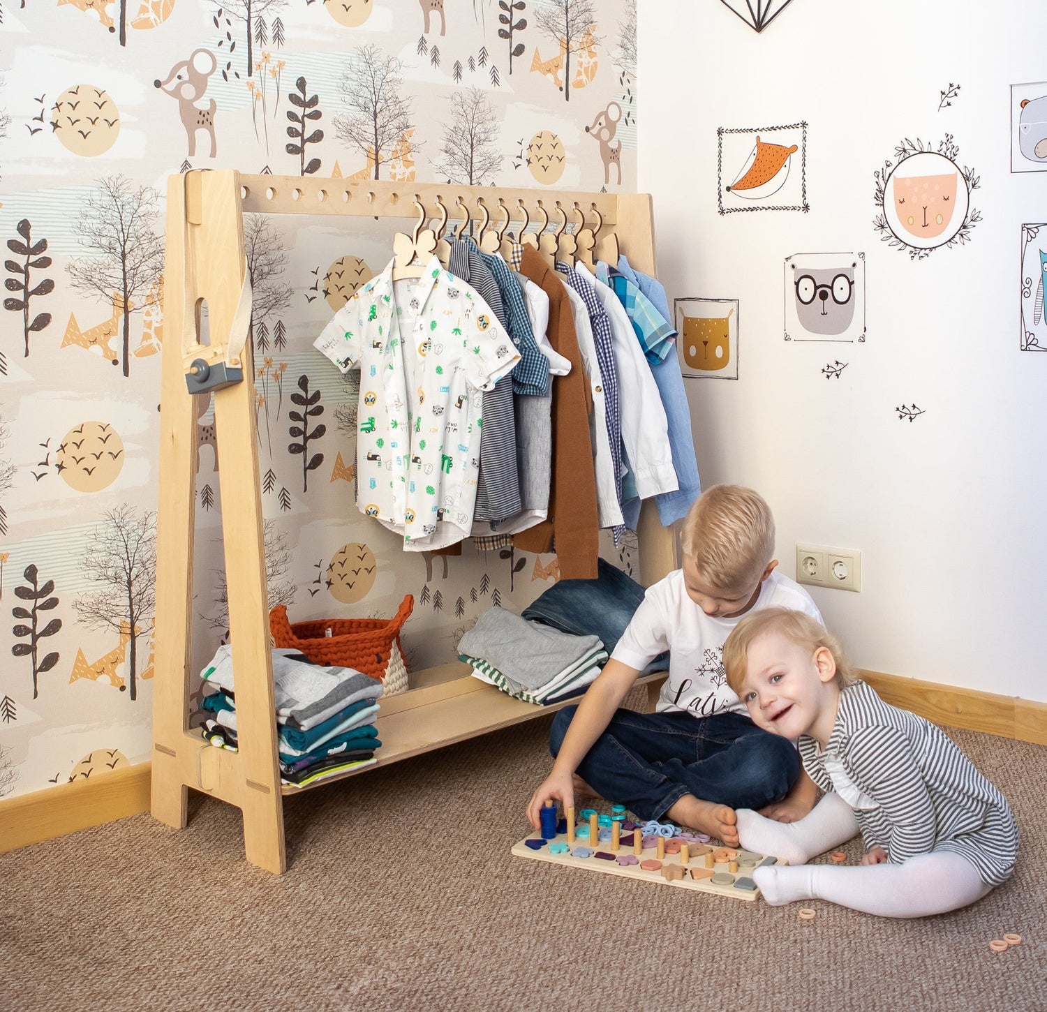 kids clothing rack and children playing in front of it