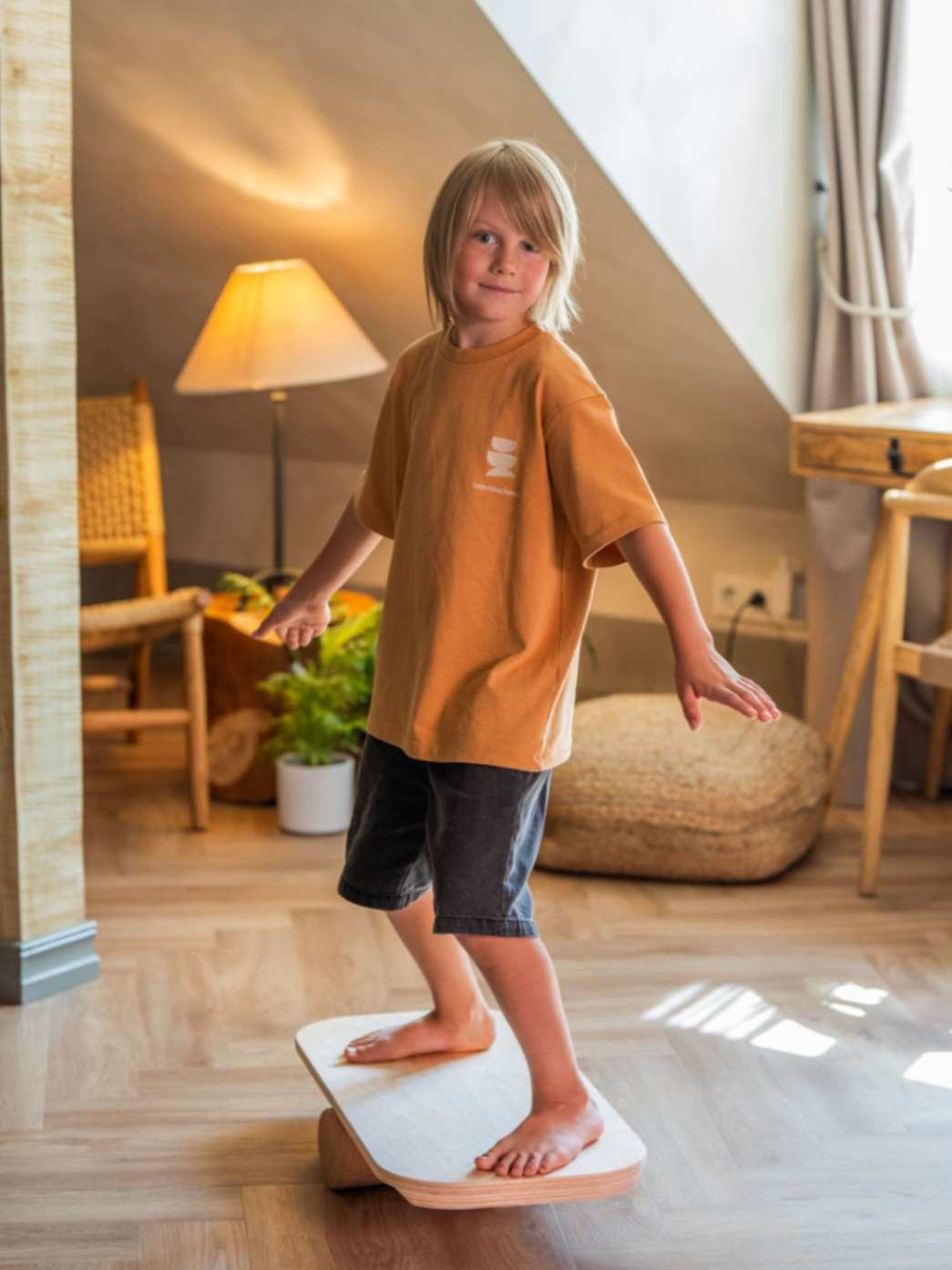 kid balancing on wooden balance board